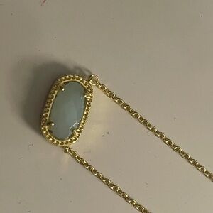 Mint green Kendra Scott necklace.
